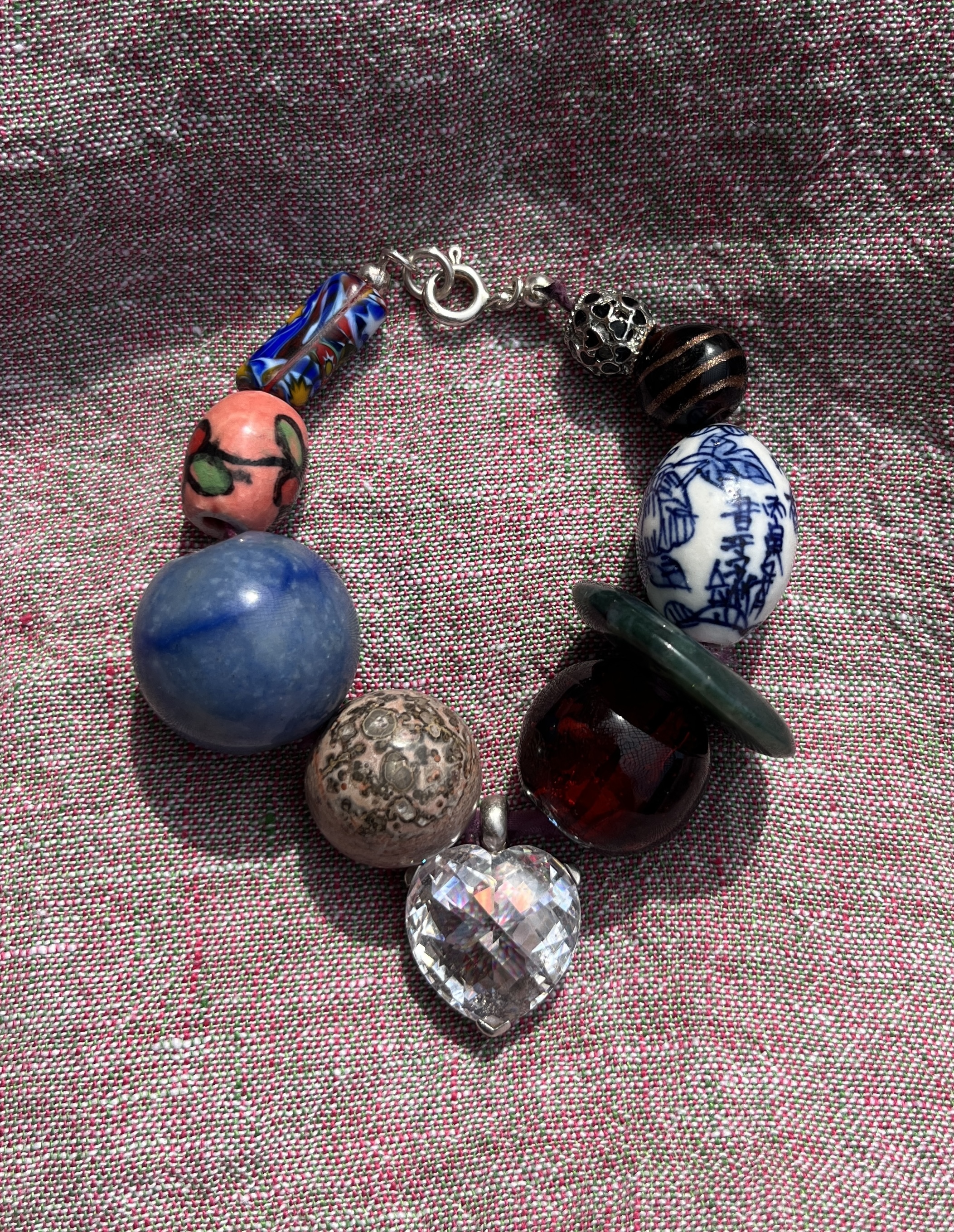 Desir handmade bracelet — white crystal heart pendant, sterling silver, Chinese porcelain, Murano glass, angelite, and jasper beads, finished with dyed silk ribbon