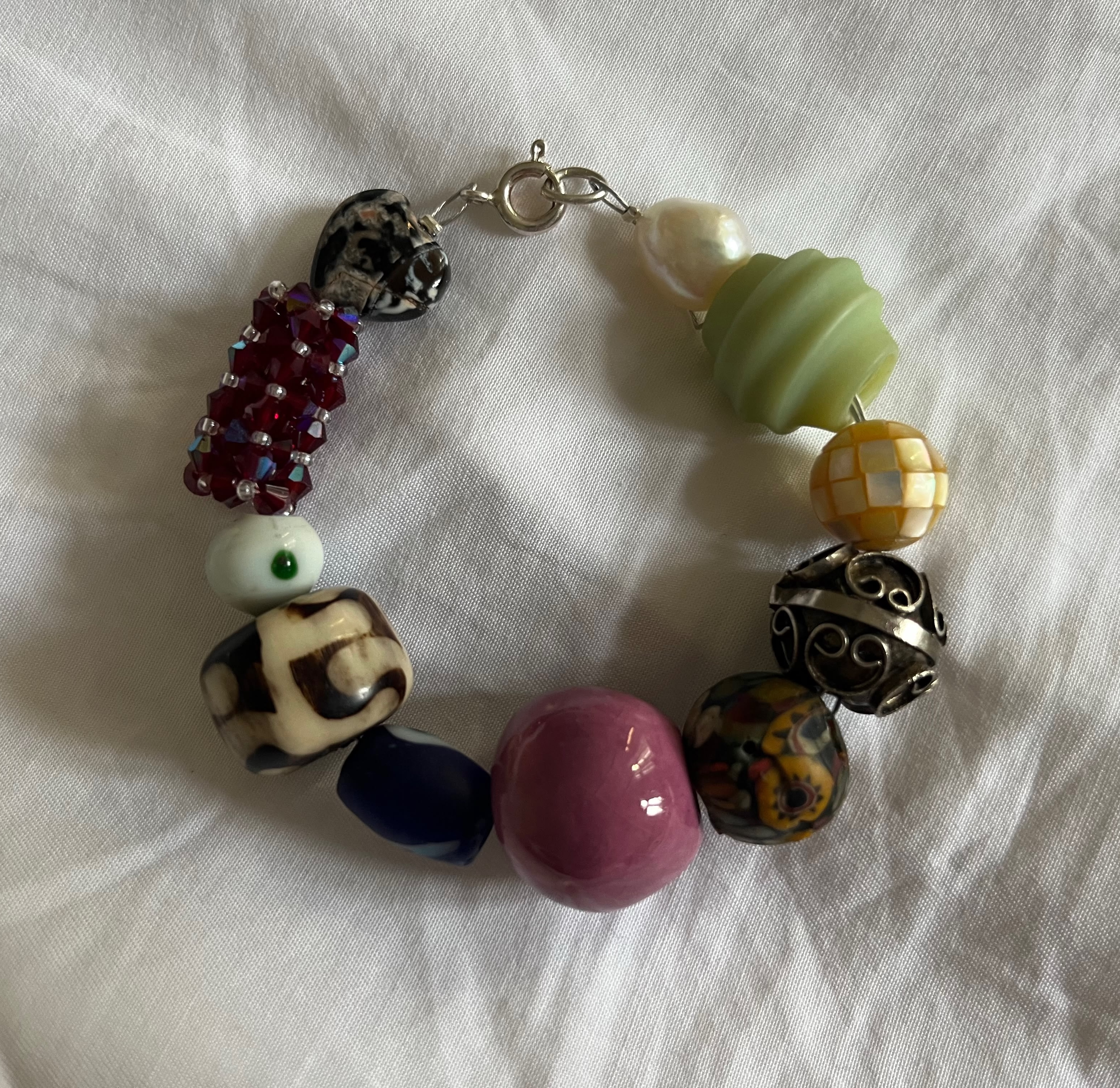 Mia handmade bracelet — fire agate heart, red cluster bead, Turkish glass, animal print bone, mauve ceramic, silver filigree, mosaic bead, jade green ribbed bead, freshwater pearl